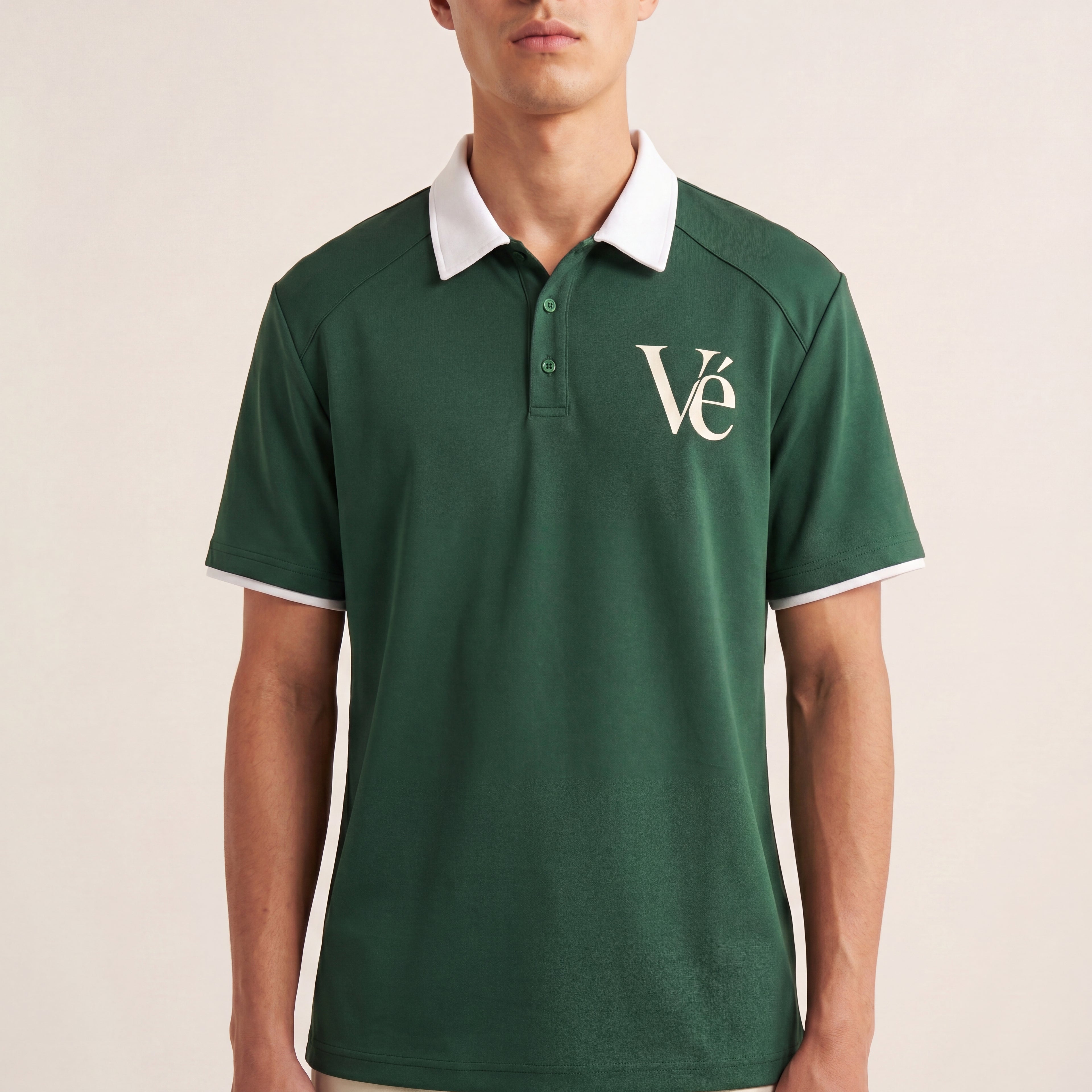The Court Polo in Dark Green, front on-body view showing the white contrast collar, sleeve trim, and cream Vé chest monogram.