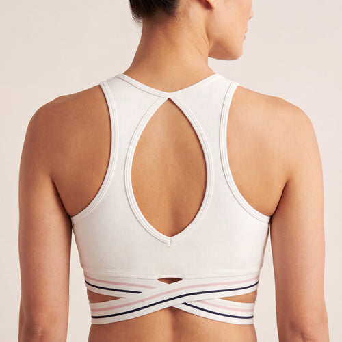 The Court Bra in White, back on-body view showing the open racerback shape and criss-cross striped band.