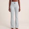 The Flare Legging in Gray, front on-body view showing the high-rise waistband, dark green Vé mark, and flared leg.