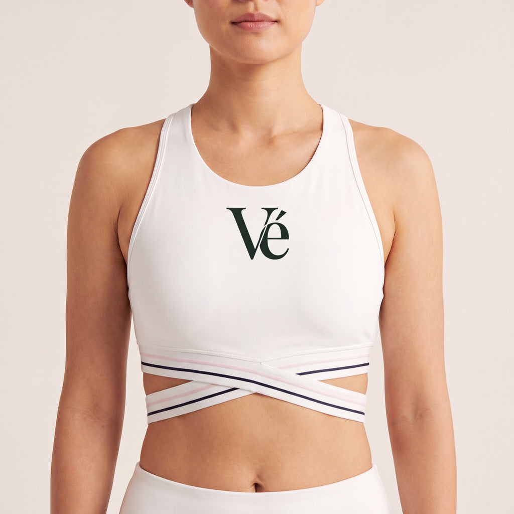 The Court Bra in White, front on-body view showing the forest Vé mark and criss-cross striped band.