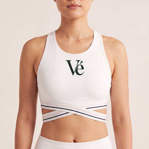 The Court Bra in White, front on-body view showing the forest Vé mark and criss-cross striped band.